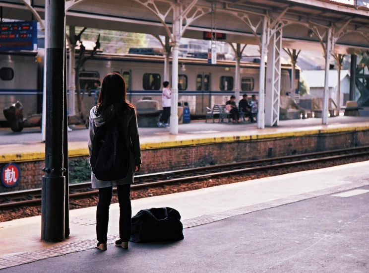 woman waiting on the platform for the train to stop