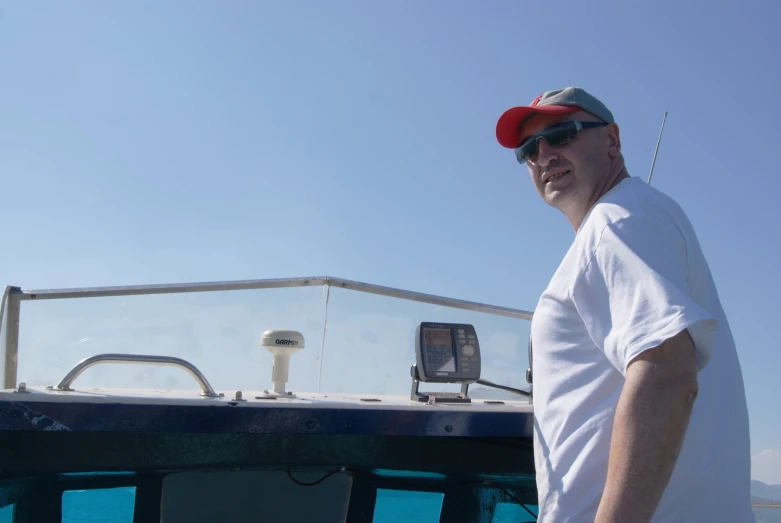 a man in glasses on the front of a boat