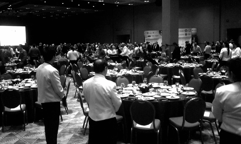 a large group of people standing in front of a conference room