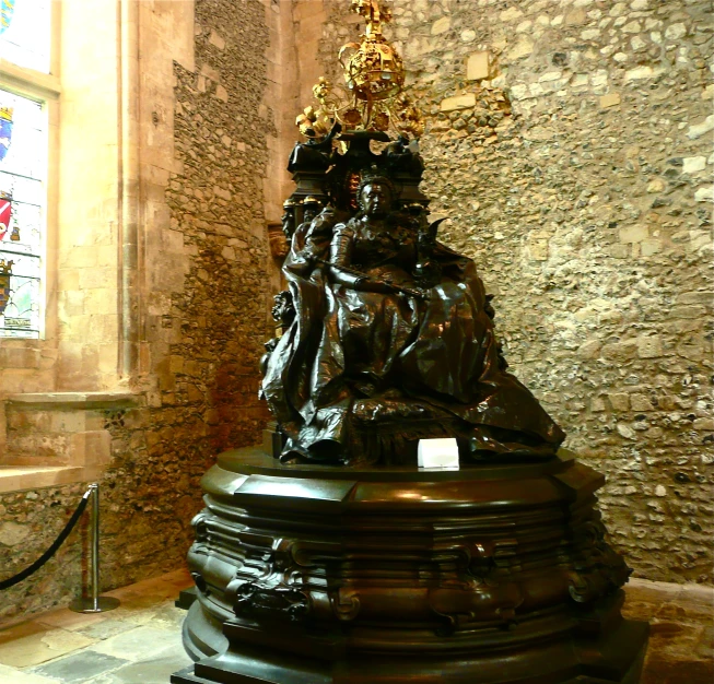 a decorative statue sits in a stone room