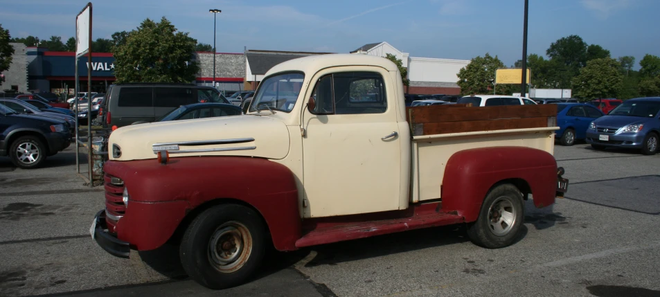 an old white truck in a parking lot