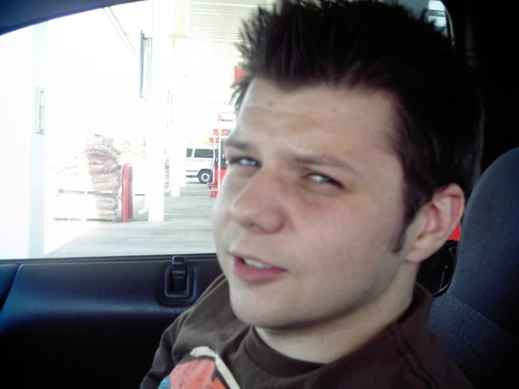 a man with a shaved head in a car