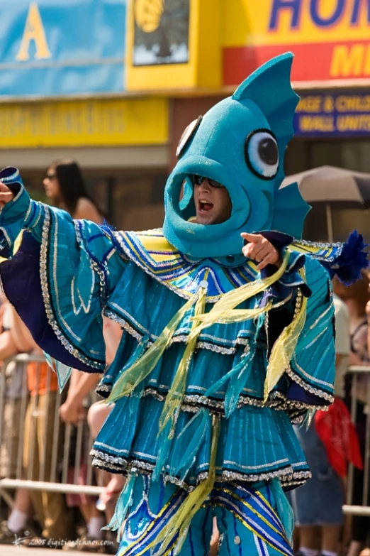 a woman in blue and gold outfit with eyes on her face