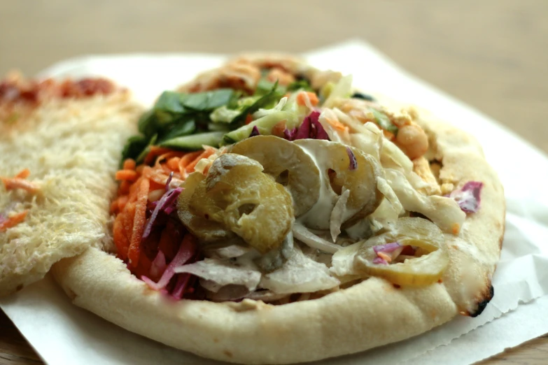 the thin flatbread pizza is covered in vegetable toppings