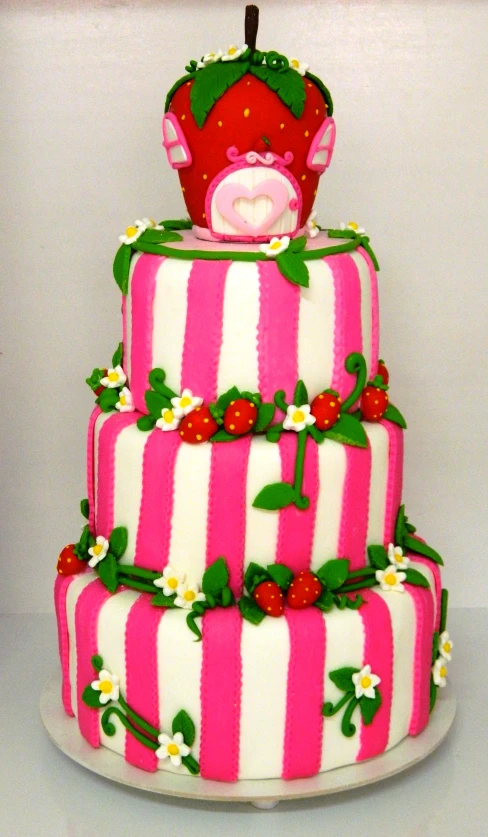 a three tiered cake has pink stripes