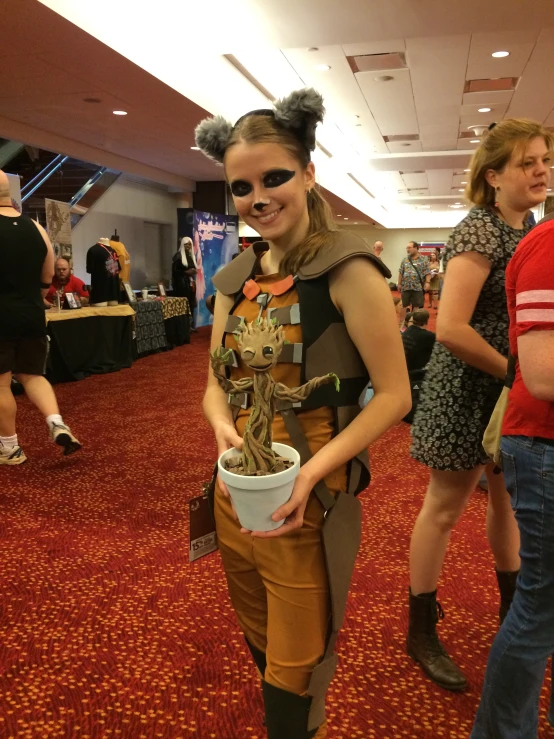 a person standing holding a bucket and a drink