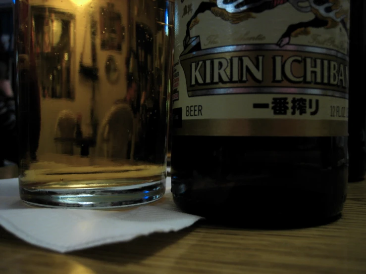 a bottle of krin ighi with a napkin on the table