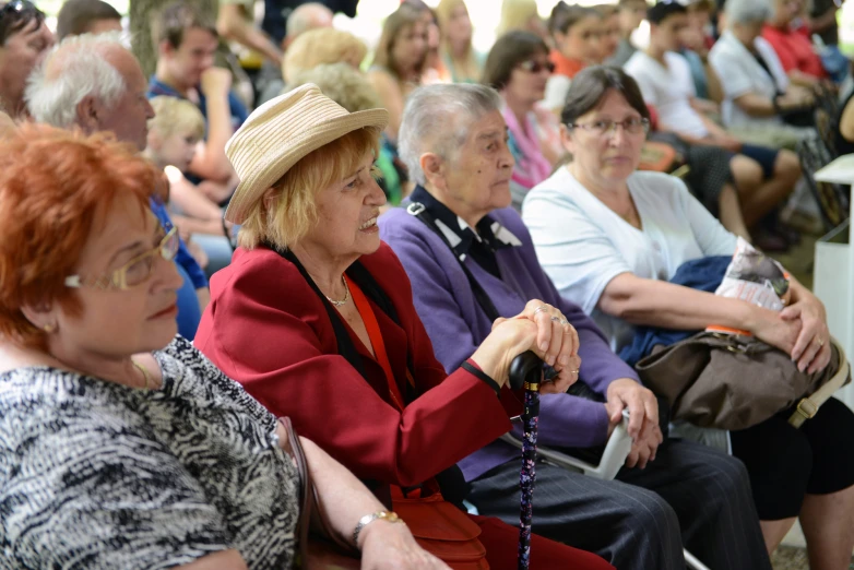 a lot of people are sitting in chairs at a rally