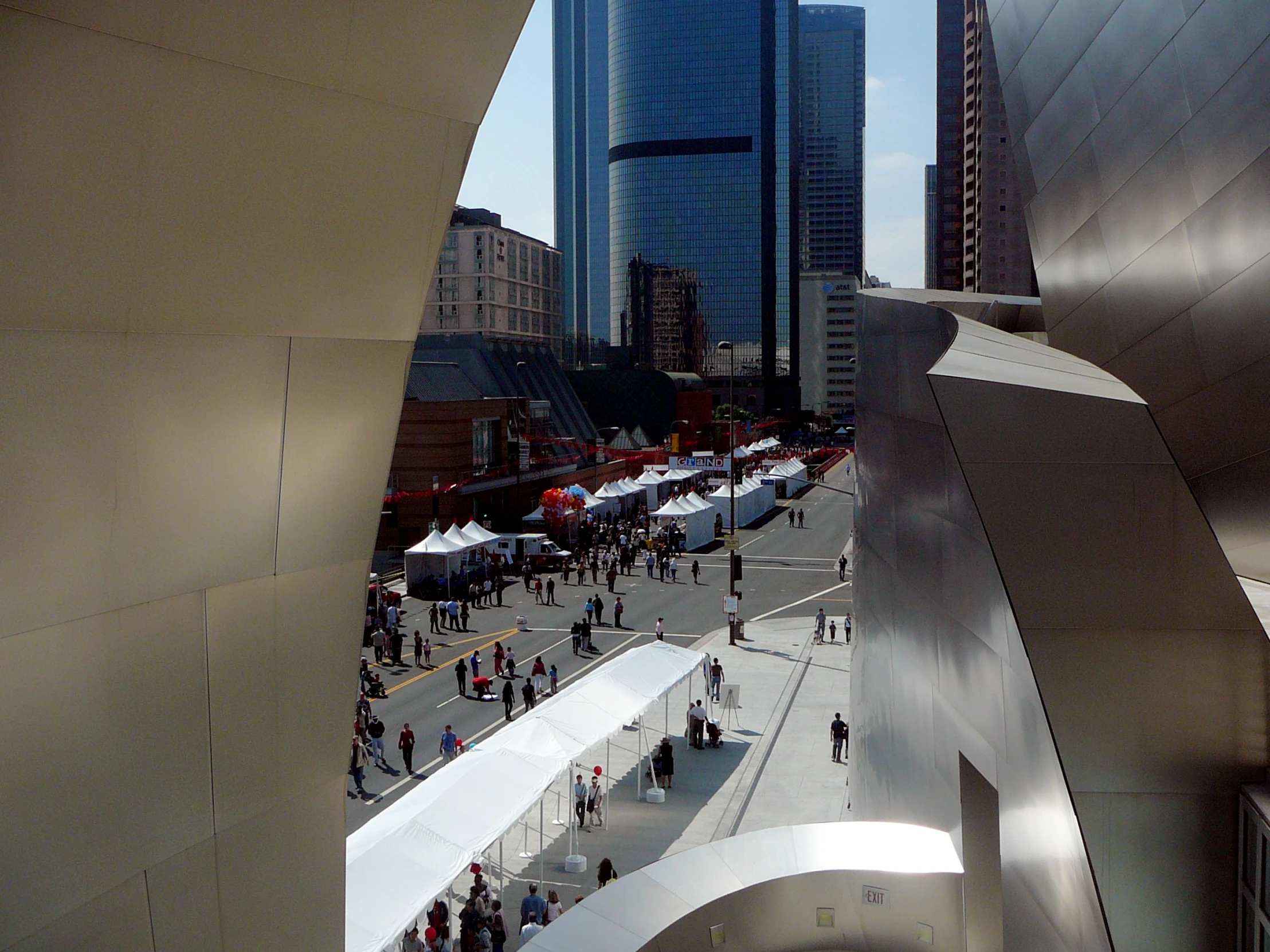 an elevated view of buildings with people walking on a sidewalk