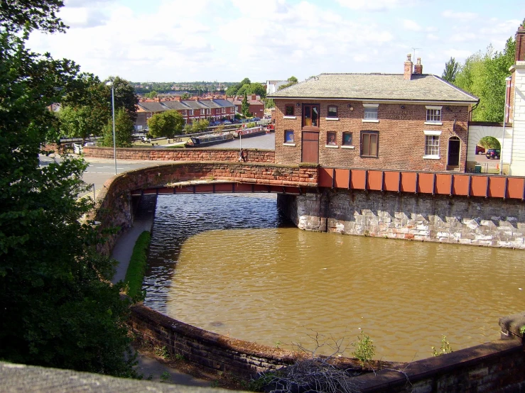 an old road is over the water on the side of a bridge