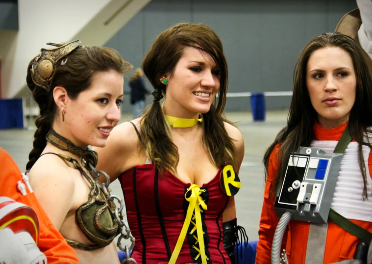 some women standing next to each other holding camera