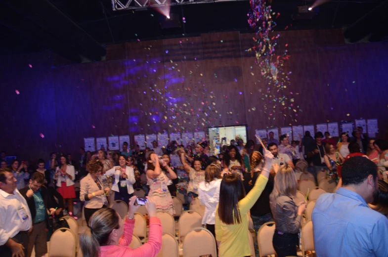 a group of people celeting in a theatre