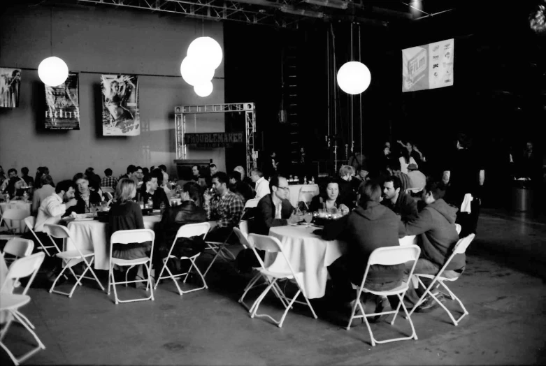 people sitting around a long table eating food