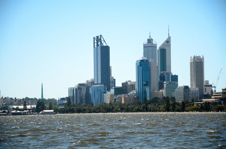 a city filled with tall buildings towering over a river