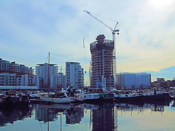 a tall building sits next to a body of water