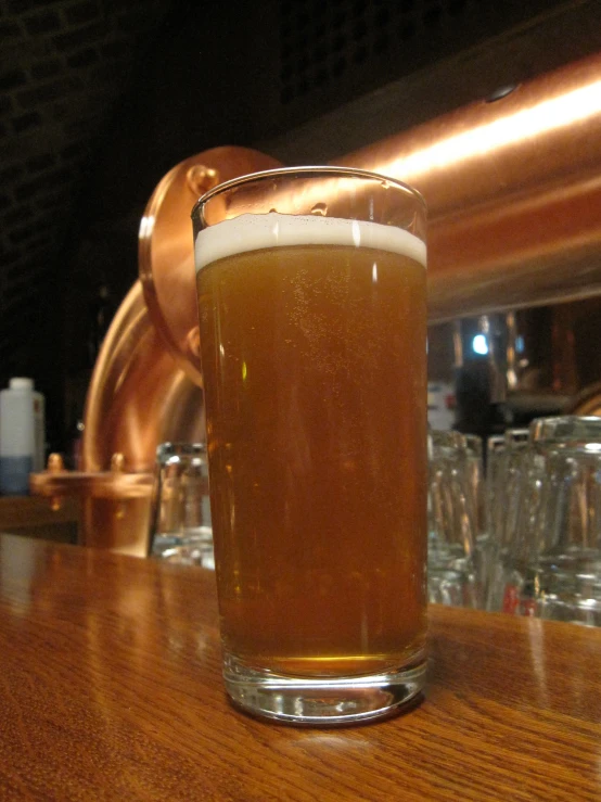 a tall glass sitting on top of a wooden table