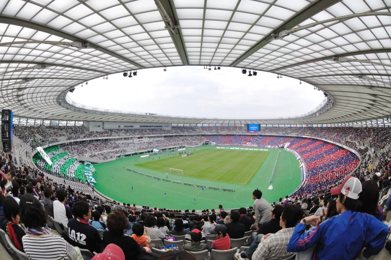 a stadium full of spectators and a few people watching