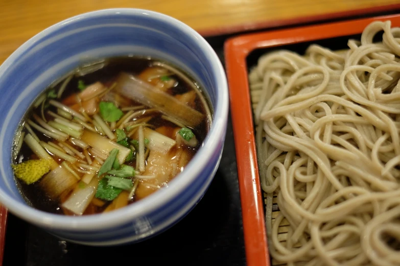 a small bowl of noodles and soup with vegetables