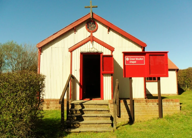 an old white church has been renovated into a vint red door