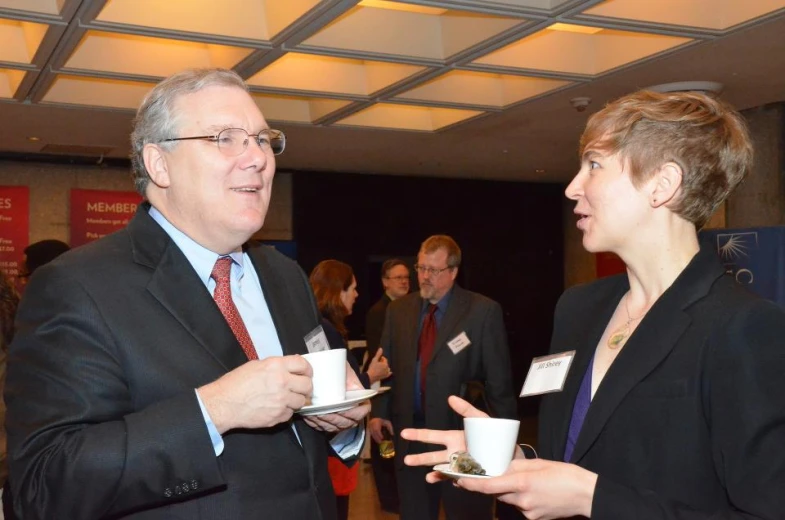 two men and woman having conversation at an event