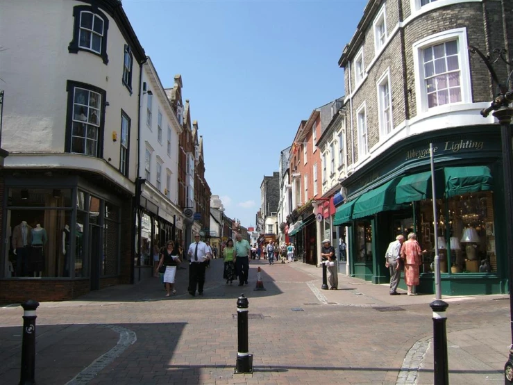 a busy street with a few people walking on the sidewalk