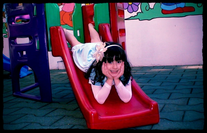 a  laying on top of a slide