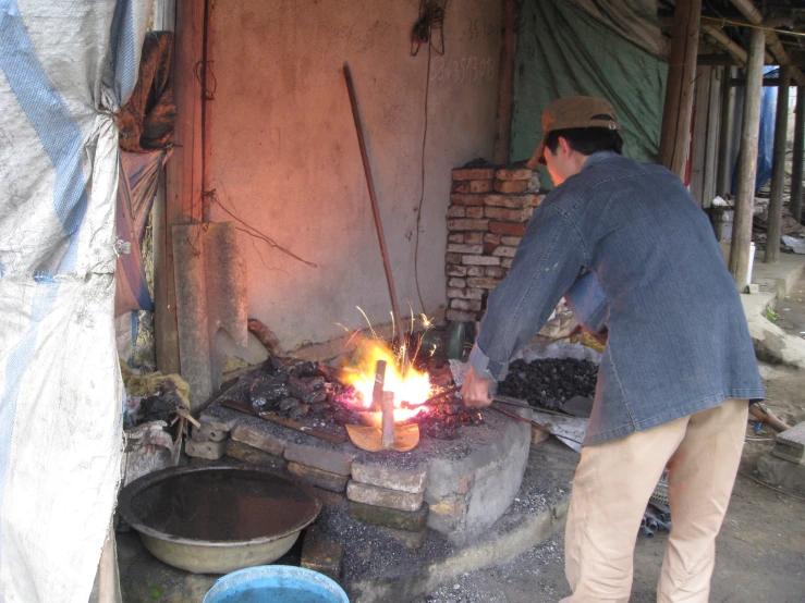 a man is cooking soing in an old outdoor oven