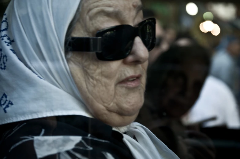 a woman wearing a headscarf and sun glasses