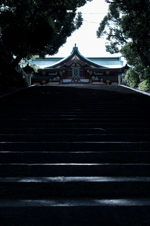 stairs lead up into a temple, with a building in the background