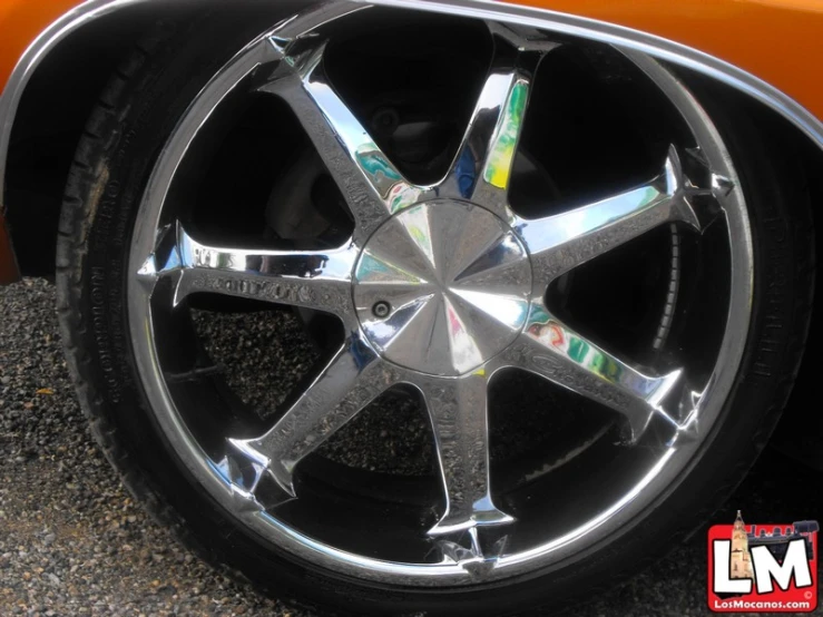 the spokes and rims of an orange car