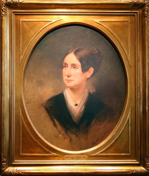 an oval portrait of a woman in a black shirt