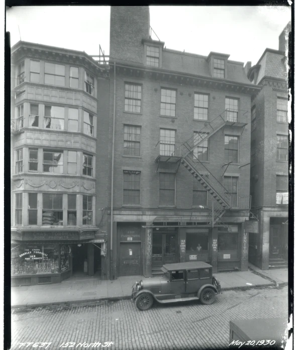 an old car is parked outside a building