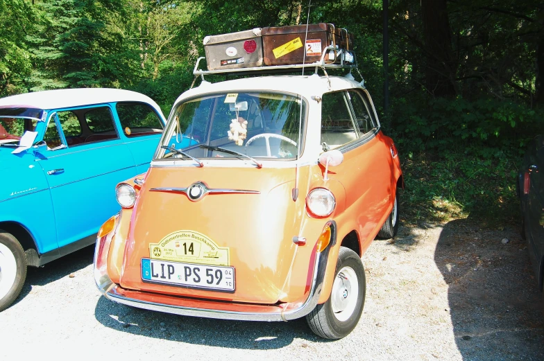 a vintage car and a vintage blue car parked in a lot