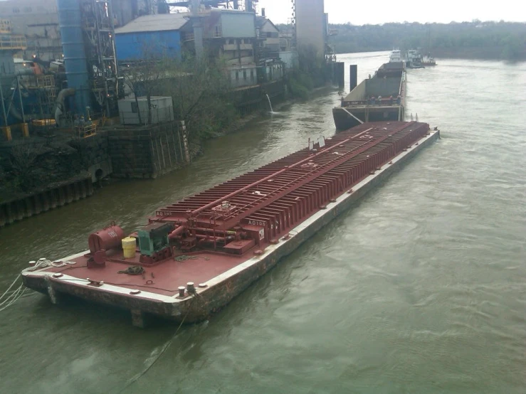 a large barge is parked in a body of water