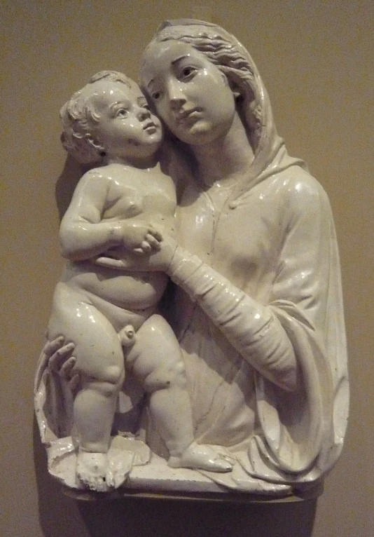 a statue that has a woman holding a baby