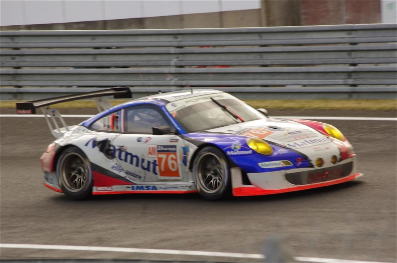 a racing car on a race track driving around the turn