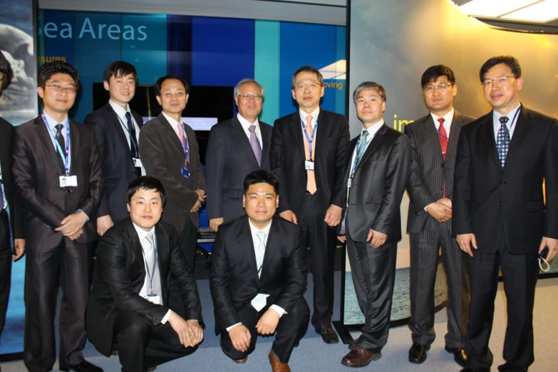 a group of men in suits pose for a picture
