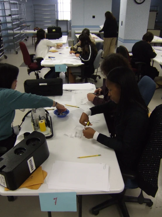 many people sit at tables to complete a food tasting project