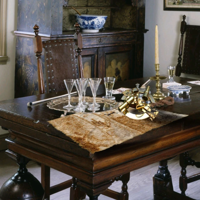 a table in a room with glasses and a wooden chair