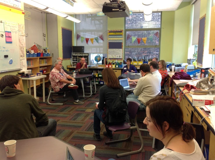 several people in a room with several computers