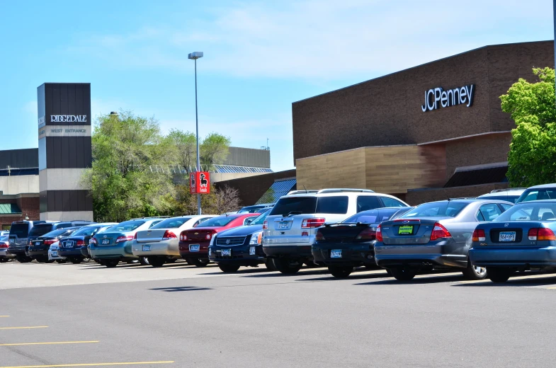 a parking lot full of parked cars outside of a building