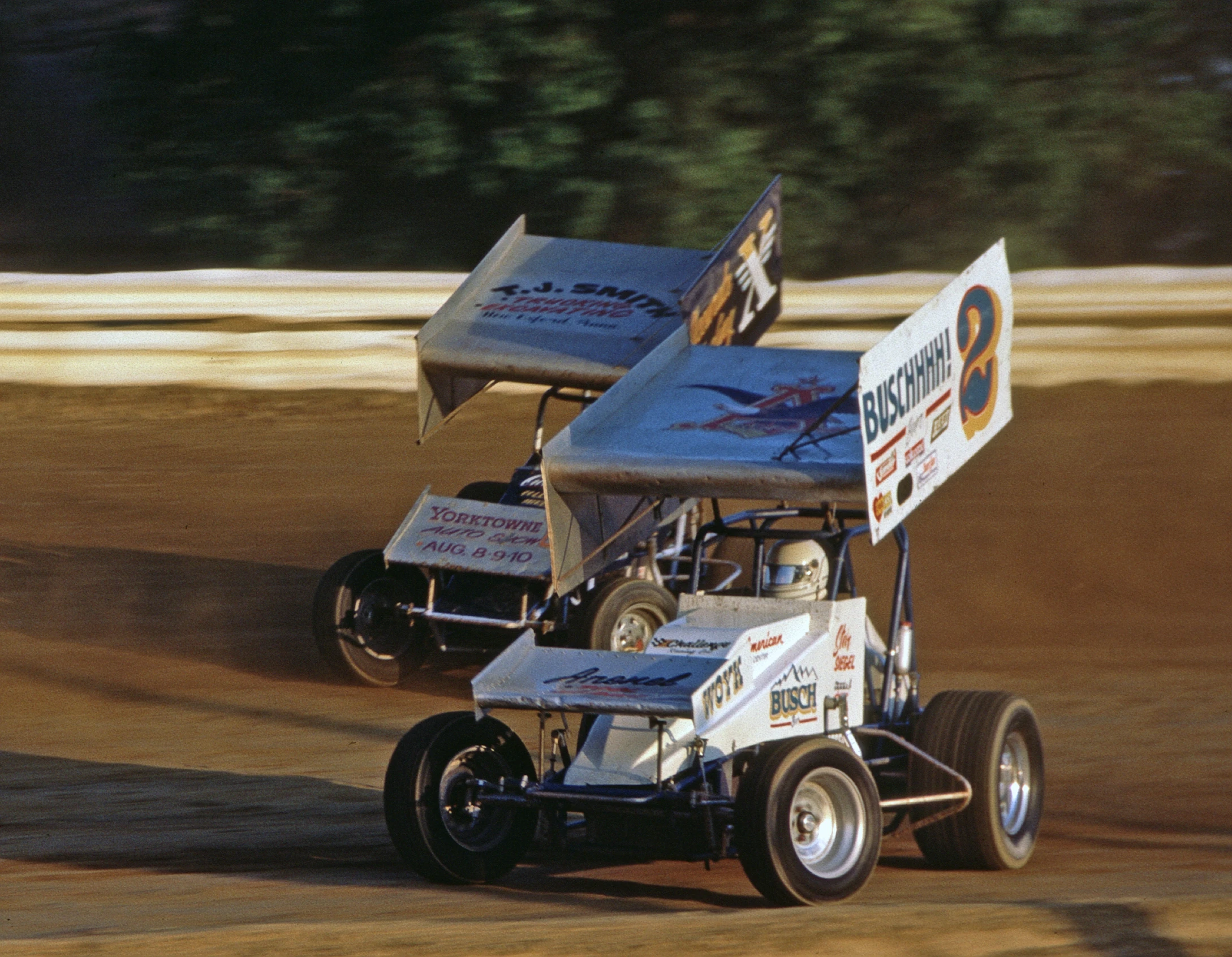 two dirt buggies racing around a track