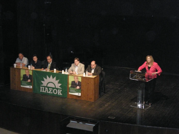 a number of people at a meeting on stage