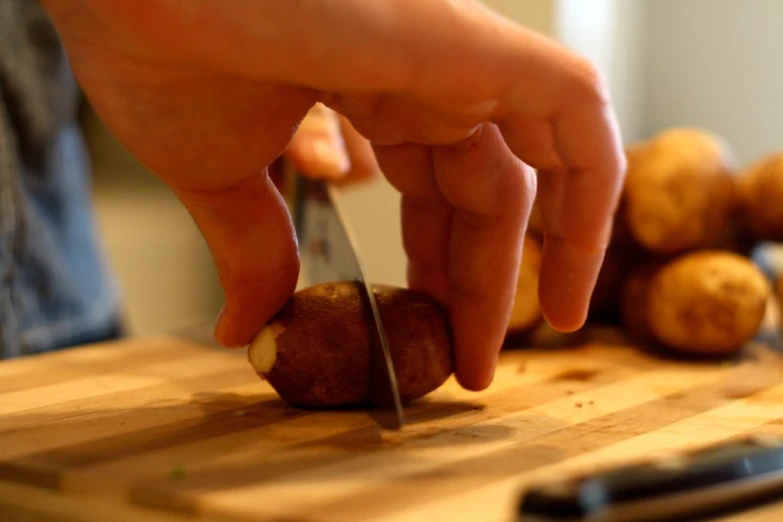 a person  a potato on a table