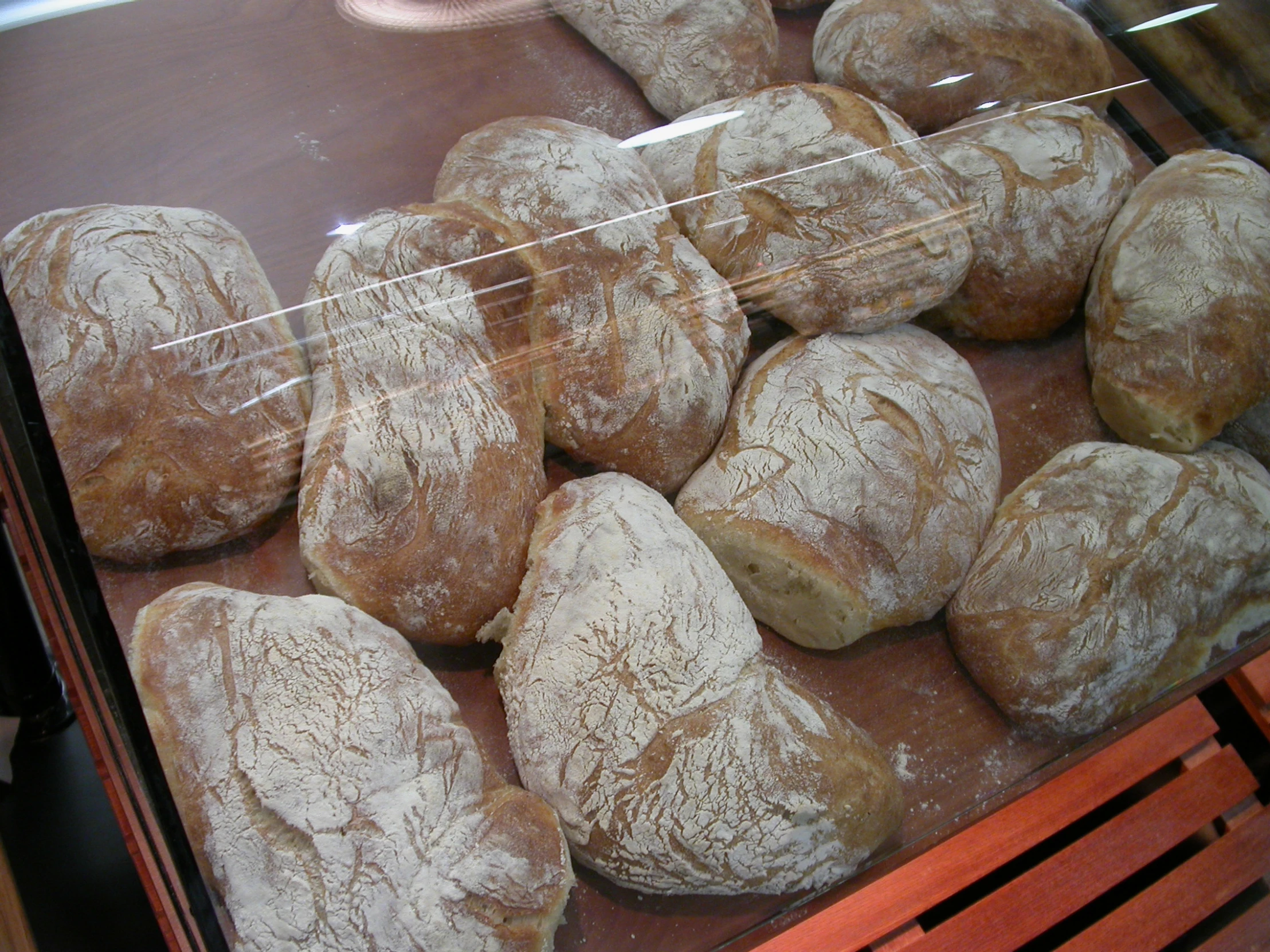 a bunch of doughnuts in a display case