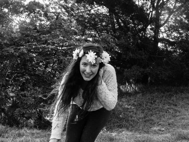 black and white pograph of woman in a park with flowers in her hair