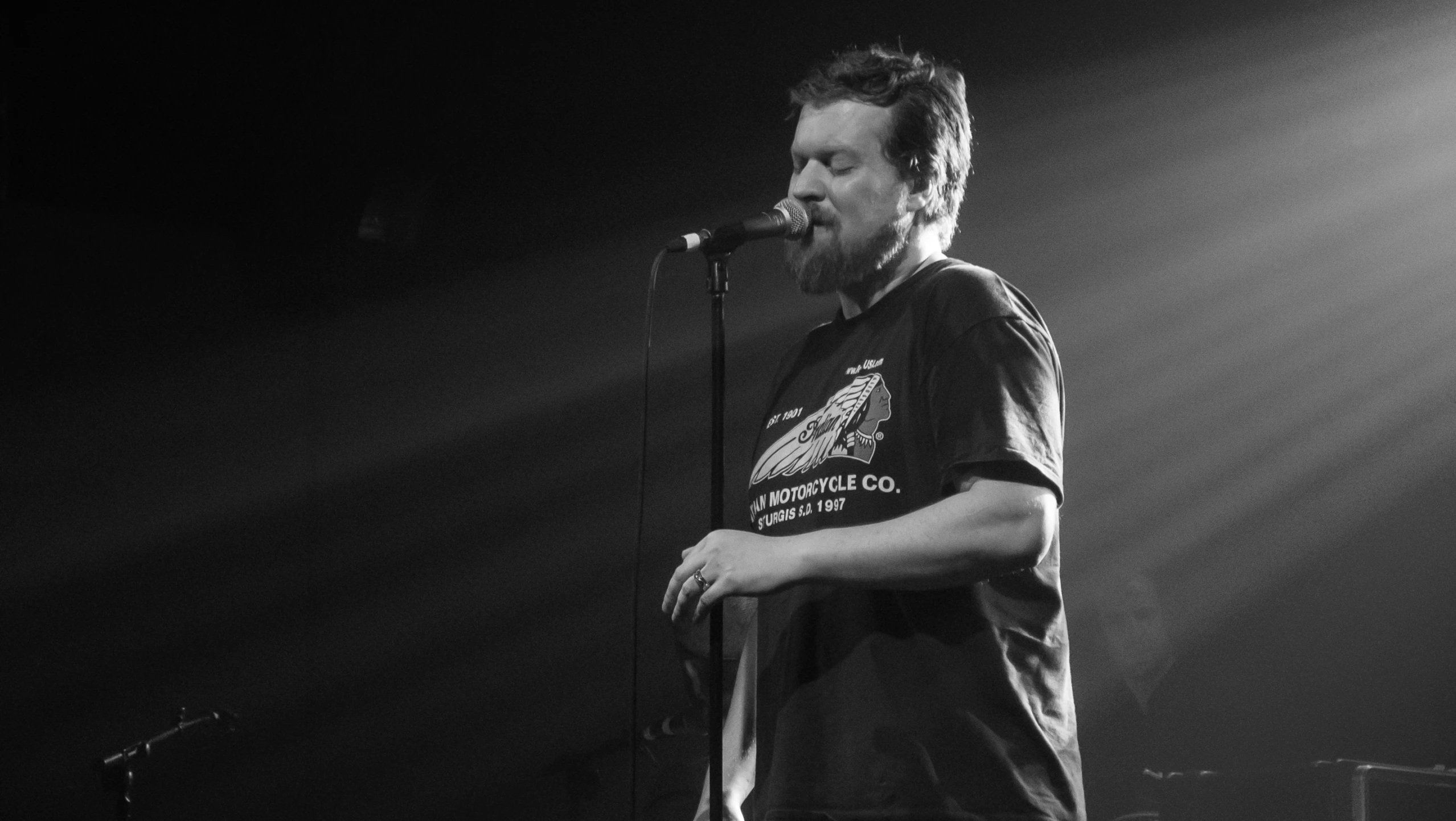 a man is singing into a microphone on stage