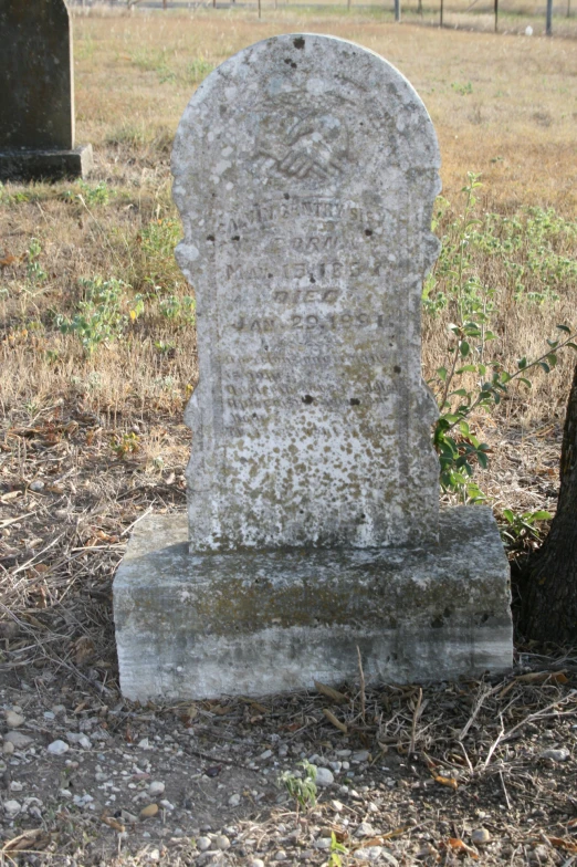 an old grave standing in the middle of a field