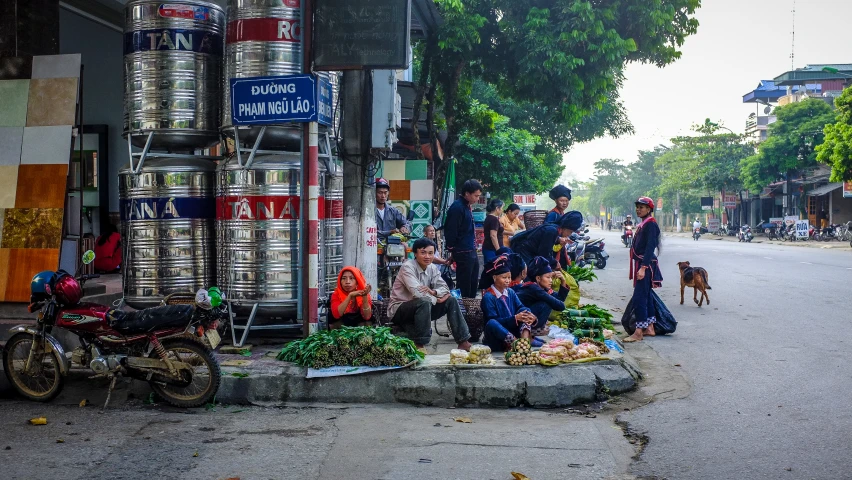 a couple of people are standing around on the side of a road