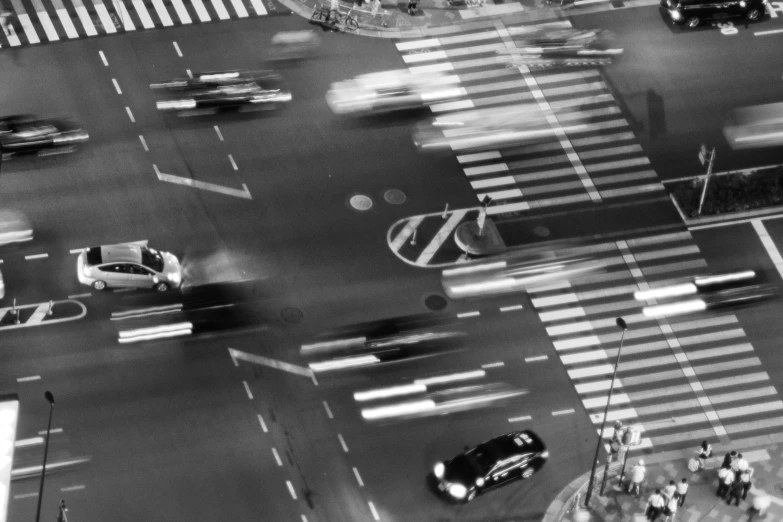 a busy intersection shows crosswalks with people walking around